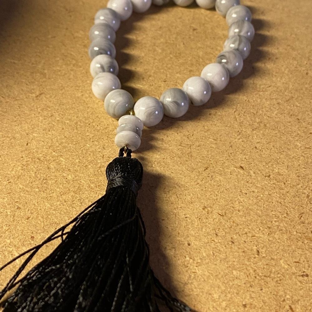 ❤️❤️A grey Rock bracelet with a black tassel.
